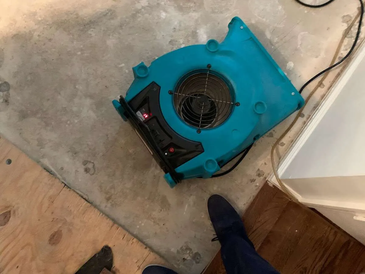 Air mover drying subfloor during Commercial Water Damage Restoration in Schaghticoke